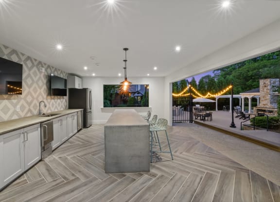 a large kitchen with a bar and a table with chairs