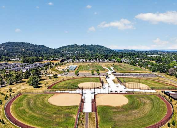 A large, open athletic track with a running track and a jumping track.