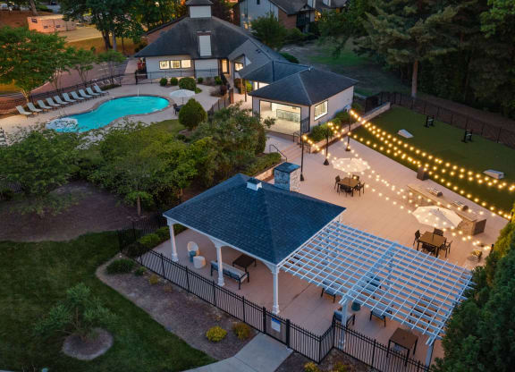 an aerial view of a pool and patio area at night