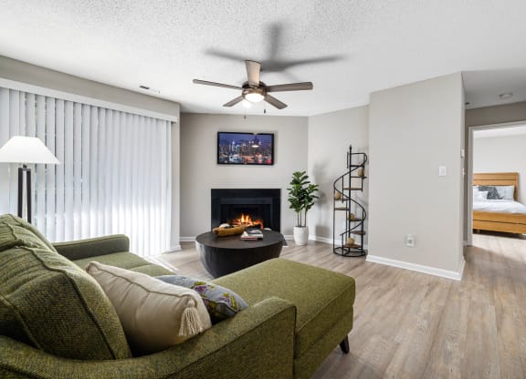 a living room with a couch and a fireplace at View at Lake Lynn, Raleigh, 27613