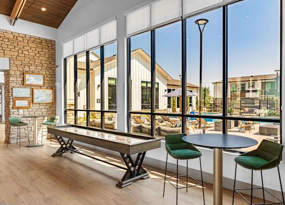 Great room with shuffle board and large windows
