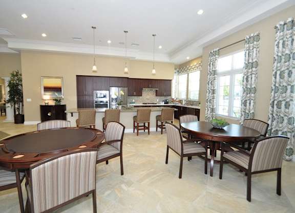 A large dining room with a round table and chairs.