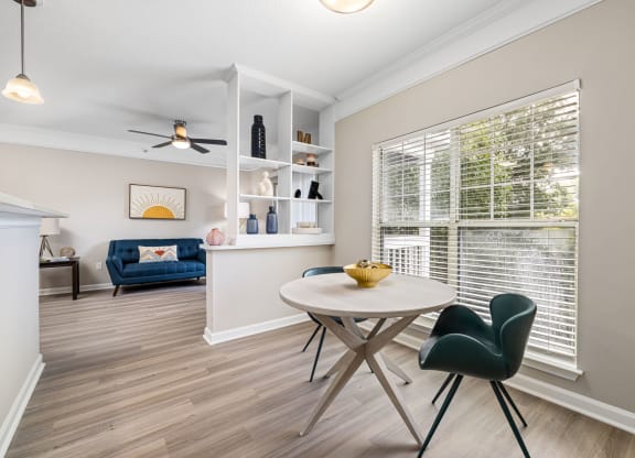 a dining room with a table and chairs and a large window at Mariners Crossing, Raleigh, 27613