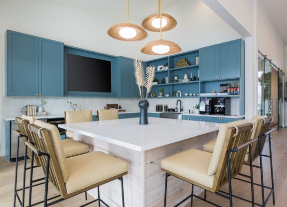 a kitchen with a marble counter top and blue cabinets