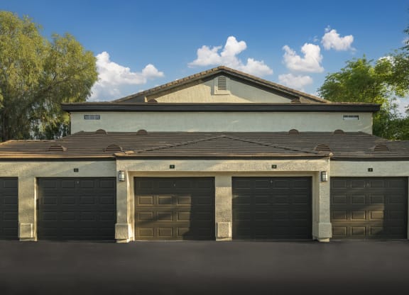a row of garage doors in front of a house