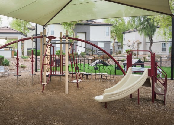 a playground with a slide and other toys in a park