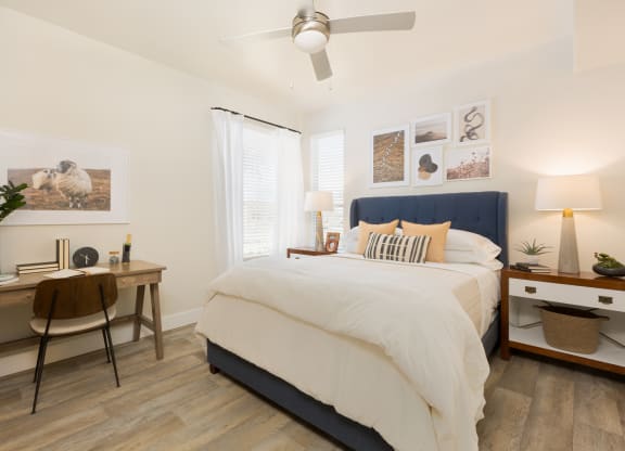 a bedroom with a bed and a desk with a chair