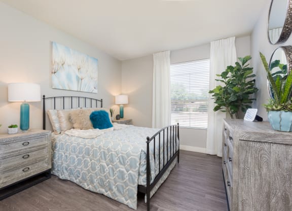 a bedroom with a bed and a window