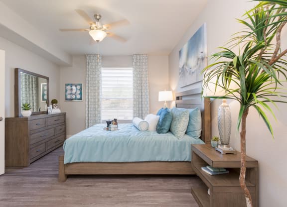 a bedroom with a large bed and a ceiling fan