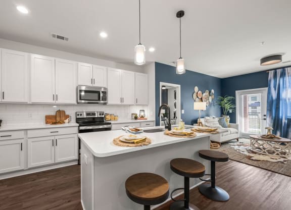 a kitchen with an island and a table with stools