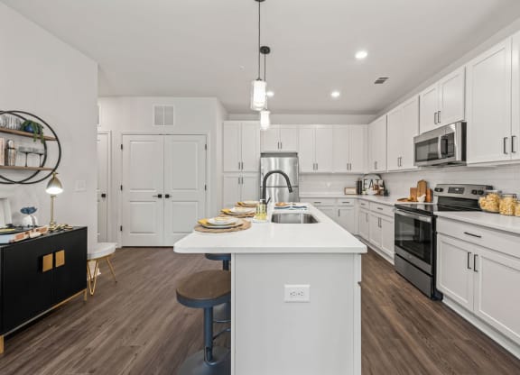 a large white kitchen with a white counter top