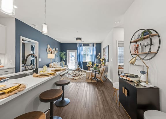 a living room with a bar and a dining room