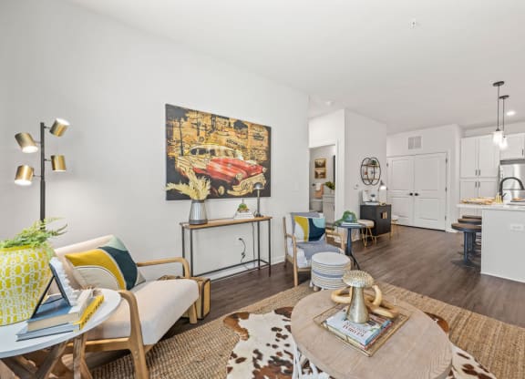 a living room and kitchen with a table and chairs