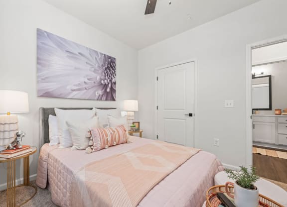 a bedroom with a bed and a painting on the wall