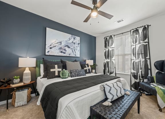 a bedroom with a bed and a ceiling fan