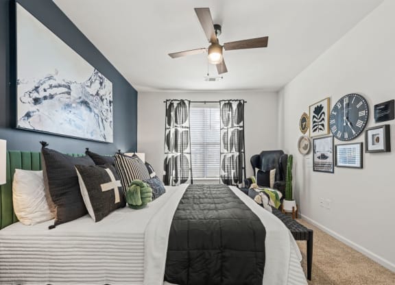 a bedroom with a bed and a ceiling fan