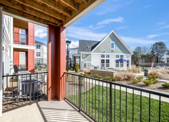 the view from the balcony of a home with a yard and a house