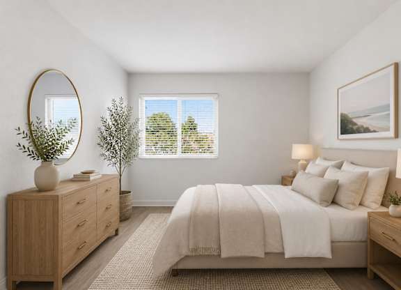 A spacious bedroom with a large bed, a dresser, and a window.