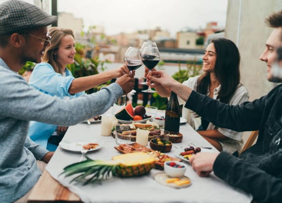 a group of people sitting around a table drinking wine