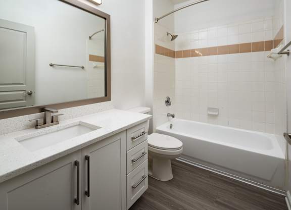 a bathroom with a sink toilet and a bath tub
