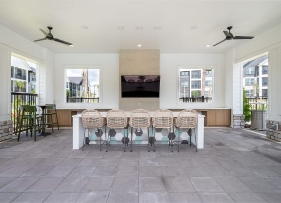 the dining room has a large table with chairs and a television