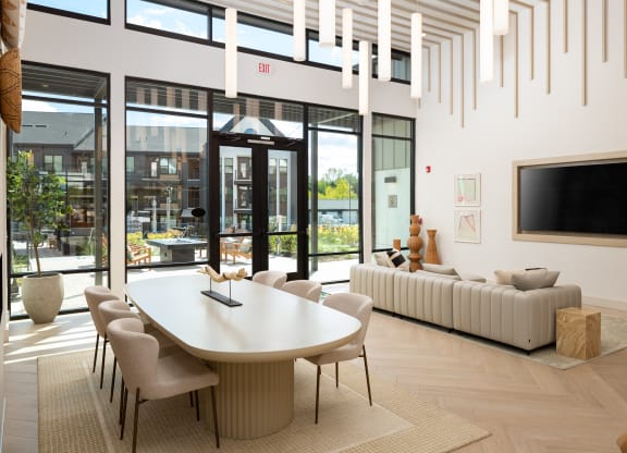a living room with a white table and chairs and large glass doors