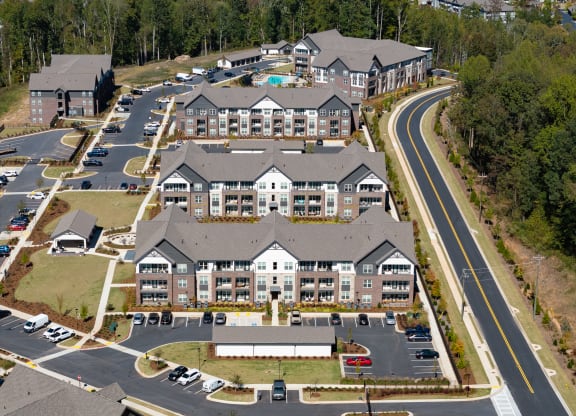 an aerial view of a large building on a road