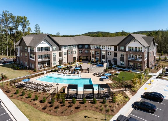 an aerial view of an apartment complex with a swimming pool