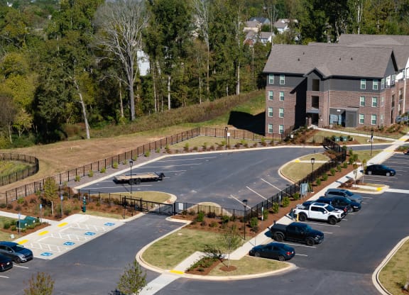 a parking lot with cars in front of a building