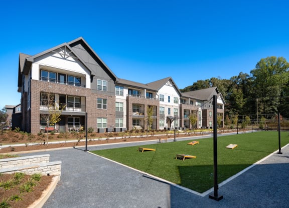 a courtyard with a tennis court in front of an apartment building