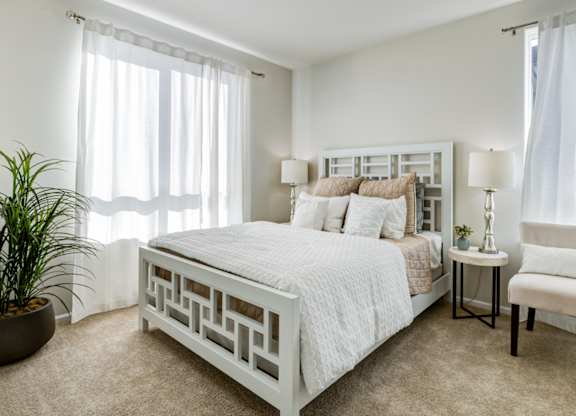 a bedroom with a bed and a chair