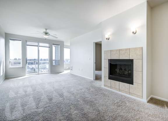 a living room with a fireplace and a ceiling fan