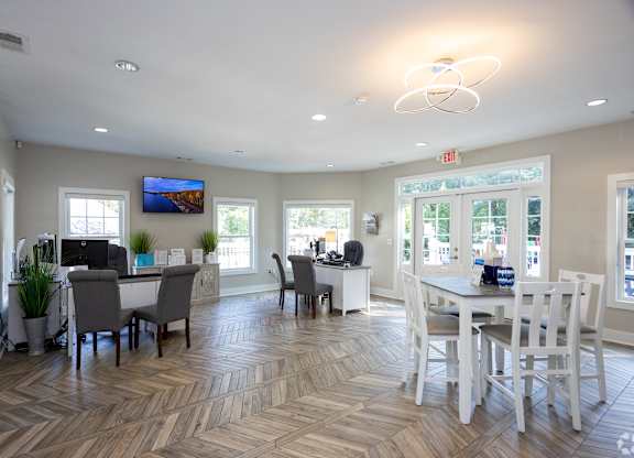 A spacious room with a dining table and chairs.