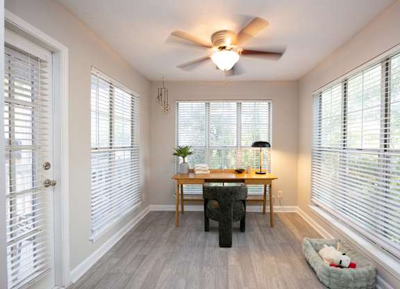 A sunny room with a table and chairs.