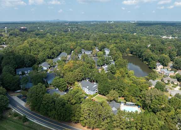 A bird's eye view of a residential area surrounded by trees.