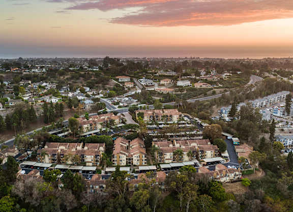 A residential area with houses surrounded by trees.