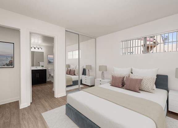A bedroom with a large bed and a painting on the wall.