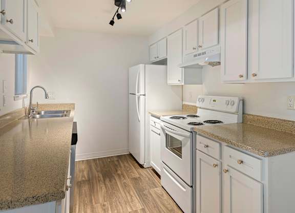 A kitchen with white appliances and cabinets.