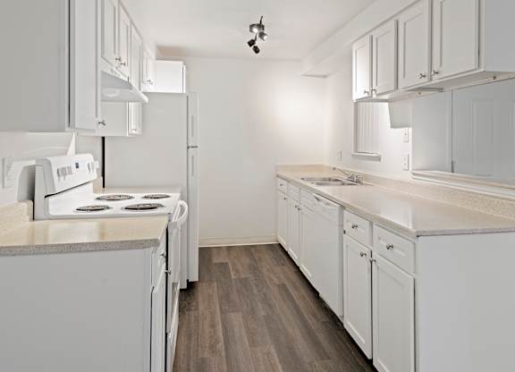 A kitchen with white appliances and cabinets.