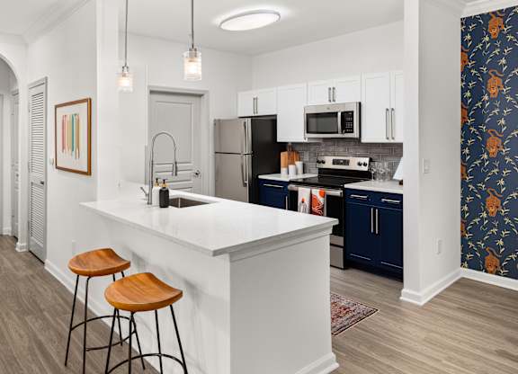 a kitchen with an island and two stools