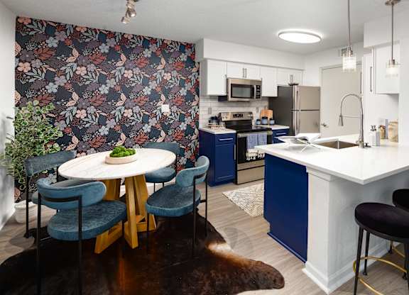 a kitchen with blue cabinets and a table and chairs