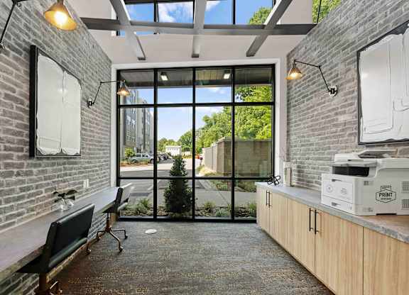 A room with a brick wall and a glass door leading outside.