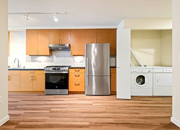 A kitchen with wooden cabinets and stainless steel appliances.