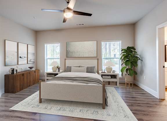 A bedroom with a large bed and a ceiling fan.