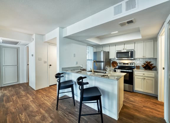 the preserve at ballantyne commons apartment kitchen with island and stools