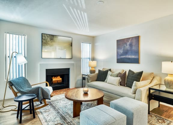 a living room with a couch and chairs and a fireplace