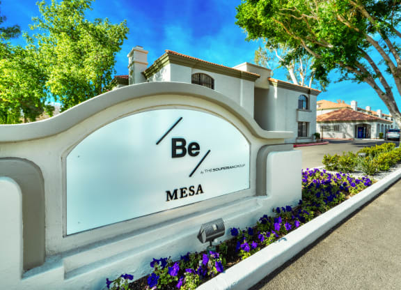 a sign that says be mesa in front of a building