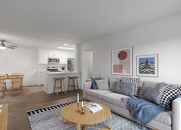 A living room with a grey couch and a coffee table.