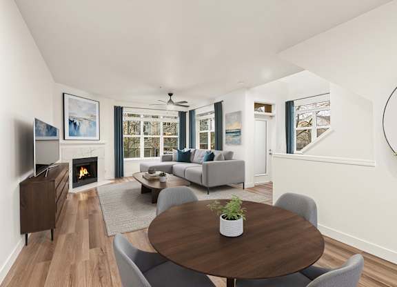 A modern living room with a fireplace and a large painting on the wall.