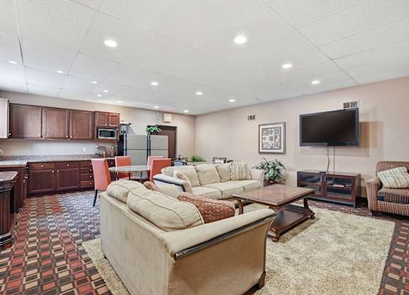 A living room with a large couch and a television.